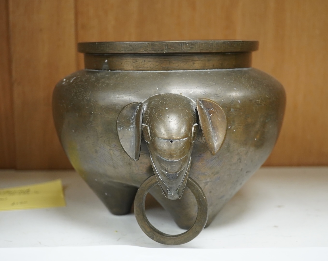 A large Chinese silver inlaid bronze elephant handled censer, signed Sishou, 19th century, 16cms high, 29cm wide. Condition - fair